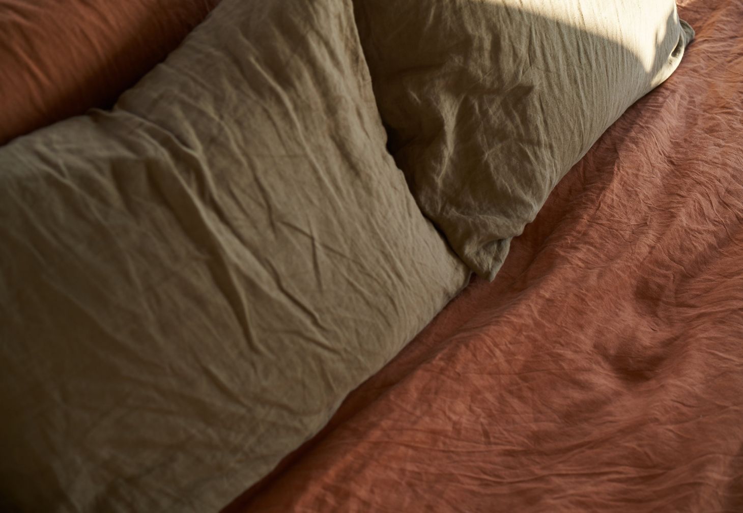 Linen duvet cover and linen pillow slips in tobacco and moss by IN BED x Triibe.